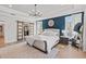 A luxurious main bedroom with a decorative chandelier, tufted headboard, and closet access at 2200 Cortland Rd, Milton, GA 30009