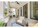 Cozy outdoor patio with wicker seating, ceiling fan, and natural light providing a relaxing atmosphere at 2200 Cortland Rd, Milton, GA 30009