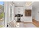 Stylish wet bar area with white cabinetry, wine cooler, and decorative backsplash at 2200 Cortland Rd, Milton, GA 30009