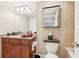 Updated bathroom with granite countertops, wood cabinets, decorative mirror and towel storage at 3481 Lakeside Ne Dr # 2203, Atlanta, GA 30326