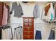 Organized walk-in closet featuring clothes and shelving with decorative cabinet for storage at 3481 Lakeside Ne Dr # 2203, Atlanta, GA 30326