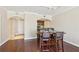 Open-concept dining area with hardwood floors is adjacent to the kitchen featuring dark cabinetry at 3481 Lakeside Ne Dr # 2203, Atlanta, GA 30326