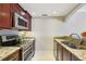 Updated kitchen features granite countertops, stainless steel appliances, and undermount sink at 3481 Lakeside Ne Dr # 2203, Atlanta, GA 30326