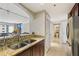Kitchen featuring granite countertops, stainless steel appliances, and a view into the living area at 3481 Lakeside Ne Dr # 2203, Atlanta, GA 30326
