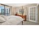 Bright main bedroom featuring a four-poster bed, balcony access, and city views at 3481 Lakeside Ne Dr # 2203, Atlanta, GA 30326