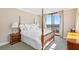 Spacious main bedroom with hardwood four-poster bed and balcony overlooking the city at 3481 Lakeside Ne Dr # 2203, Atlanta, GA 30326