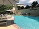 Relaxing community pool with lounge chairs, tables, umbrellas, and lush green surroundings at 3481 Lakeside Ne Dr # 2203, Atlanta, GA 30326