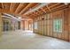 Expansive unfinished basement framed with wood, featuring multiple windows for natural light at 545 Slane Trce, Roswell, GA 30076