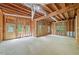 Unfinished basement framed with wood, featuring multiple windows and an entry door at 545 Slane Trce, Roswell, GA 30076