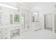 Well-lit bathroom suite with mirrored walls, white vanity, make up counter, and glass enclosed shower at 545 Slane Trce, Roswell, GA 30076