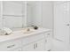 Bathroom featuring white cabinets, a large mirror, and elegant finishes at 545 Slane Trce, Roswell, GA 30076