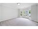 Bedroom with neutral carpet and a bay window showcasing neighborhood view at 545 Slane Trce, Roswell, GA 30076