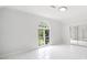 Bright bedroom features tiled floors, a large window, and mirrored closet doors at 545 Slane Trce, Roswell, GA 30076