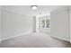 Bright bedroom with neutral carpet and large window offering natural light at 545 Slane Trce, Roswell, GA 30076