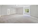 Large bedroom with trim, big window, and adjacent door to the en-suite bathroom at 545 Slane Trce, Roswell, GA 30076