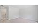 Bedroom featuring neutral carpet, white trim, and a doorway leading to a bathroom at 545 Slane Trce, Roswell, GA 30076