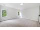 Spacious bedroom with neutral carpet, white trim, and large windows providing natural light at 545 Slane Trce, Roswell, GA 30076