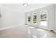 Sun-filled bonus room with neutral tile, arch topped windows, and views of the green exterior at 545 Slane Trce, Roswell, GA 30076