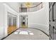 Elegant foyer features high ceilings, a curved staircase, hardwood floors, and decorative lighting at 545 Slane Trce, Roswell, GA 30076