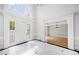 Bright foyer with tiled floors, high ceilings, glass paneled front door and sidelights, and an open view to the living spaces at 545 Slane Trce, Roswell, GA 30076