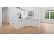 The kitchen features a large center island, white countertops, and a view of the backyard from a large window at 545 Slane Trce, Roswell, GA 30076