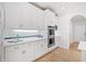 A closer view of the kitchen featuring white countertops and backsplash, custom cabinets, and stainless appliances at 545 Slane Trce, Roswell, GA 30076