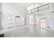 Open living space with large windows, high ceilings, built-in cabinets, and a view of the upper level loft at 545 Slane Trce, Roswell, GA 30076