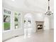 Bright living room showcases fireplace, archways, beautiful chandelier, and large windows overlooking the manicured lawn at 545 Slane Trce, Roswell, GA 30076