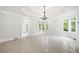 Spacious primary bedroom boasts beautiful floors, multiple windows, tray ceiling and an adjacent bath at 545 Slane Trce, Roswell, GA 30076