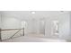 Open upstairs landing area features neutral carpeting and a staircase with wooden banister at 545 Slane Trce, Roswell, GA 30076