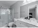 Bathroom featuring a glass shower, toilet, sink, and mirror at 904 Little River Ln, Woodstock, GA 30189
