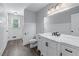 Bathroom featuring a toilet, sink, mirror, and decorative lighting at 904 Little River Ln, Woodstock, GA 30189