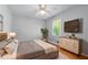 Bedroom with a large bed, mounted TV, and wood floors at 904 Little River Ln, Woodstock, GA 30189