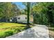 Charming home with a long driveway and well-maintained lawn surrounded by mature trees at 904 Little River Ln, Woodstock, GA 30189
