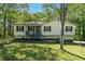 Charming single-story home with a well-maintained lawn and mature trees at 904 Little River Ln, Woodstock, GA 30189