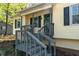 Inviting front porch with wood railings and steps leading to the entrance of the house at 904 Little River Ln, Woodstock, GA 30189