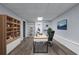 Well-lit home office with built-in bookshelves, desk, and comfortable office chair at 904 Little River Ln, Woodstock, GA 30189