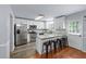 Bright kitchen with stainless steel appliances, granite countertops, and breakfast bar seating at 904 Little River Ln, Woodstock, GA 30189