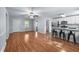Open-concept living and kitchen area featuring hardwood floors, stainless steel appliances, and a breakfast bar at 904 Little River Ln, Woodstock, GA 30189