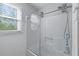 Bathroom with a glass door shower and window with natural light at 904 Little River Ln, Woodstock, GA 30189
