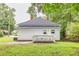 Exterior view of the backyard with a small deck at 13 E Palmetto St, Porterdale, GA 30014