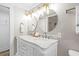Elegant bathroom featuring dual sinks, white marble countertop and decorative mirrors at 13 E Palmetto St, Porterdale, GA 30014