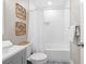 A tub and shower combination are in a bathroom that includes blue and white patterned flooring at 13 E Palmetto St, Porterdale, GA 30014