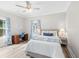 Relaxing bedroom featuring desk, bed, blue accents and large windows for natural light at 13 E Palmetto St, Porterdale, GA 30014