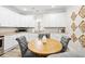 Eat-in kitchen features granite countertops, modern appliances, and hardwood floors at 13 E Palmetto St, Porterdale, GA 30014