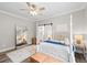 Bright main bedroom with four-poster bed, sliding barn door and plenty of natural light at 13 E Palmetto St, Porterdale, GA 30014