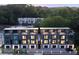 Aerial view of modern townhouses with rooftop decks surrounded by lush green trees at 1570 Flat Shoals Se Rd # 4, Atlanta, GA 30316