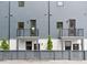 Modern townhome exterior with gray siding, black railings, and fenced yard at 1570 Flat Shoals Se Rd # 4, Atlanta, GA 30316