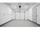 Clean and empty garage with a white door and epoxy flooring at 1570 Flat Shoals Se Rd # 4, Atlanta, GA 30316