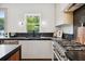 Well-lit kitchen features stone countertops, stainless appliances, and modern finishes at 1570 Flat Shoals Se Rd # 4, Atlanta, GA 30316